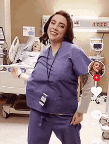 a woman in scrubs is dancing in a hospital room .