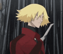 a man with blonde hair is holding a knife in his hand