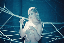 a naked woman holding a string of beads in her hands