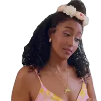 a woman with a flower in her hair wearing a pink and yellow top