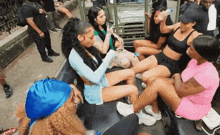 a group of women are sitting on the back of a jeep