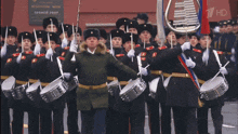a group of people marching in front of a sign that says 1 hd