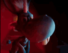 a close up of a person 's mouth with a blue object coming out of it