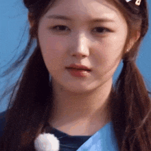 a close up of a woman 's face with two pigtails