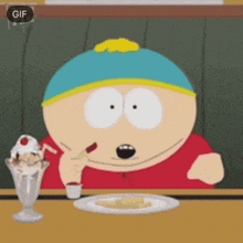 a cartoon character from south park is sitting at a table eating a cheesecake .