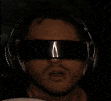 a man wearing headphones and a pair of glowing glasses with the word doomsday on them