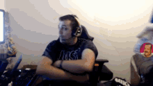 a man wearing headphones and a t-shirt that says just