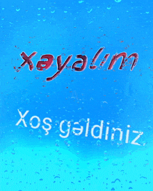 a blue background with water drops and the words xeyalim ailesine xos gaidiniz