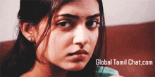 a close up of a woman 's face with the words global tamil chat.com written below her