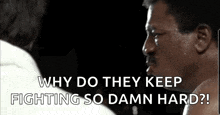 a man with a mustache is talking to another man in a boxing ring while they are fighting .