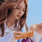 a woman is holding a bunch of beans in her hands .