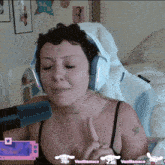 a woman wearing headphones is talking into a microphone with vanillamace written on the bottom right
