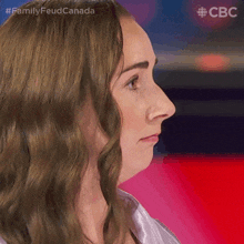 a close up of a woman 's face with the words family feud canada on the bottom right