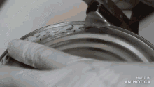 a person is opening a can with the words made in animatica written on the bottom