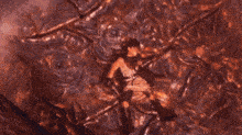 a cartoon character is laying on the ground with a glowing object in his hand