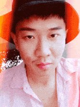 a young man wearing a hat and a white shirt is looking at the camera
