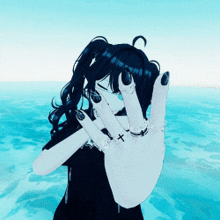 a girl with black nails and a cross on her finger