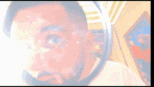 a man looking through a magnifying glass with a painting in the background