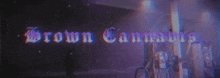 a person standing in front of a sign that reads brown cannabis