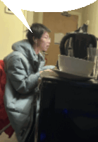 a woman sitting at a desk with a speech bubble above her