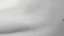 a cartoon character is crawling in the snow wearing a red hat