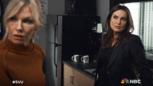 two women standing next to each other in a kitchen with a nbc logo on the bottom right