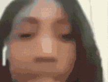 a close up of a woman 's face with a blurred background