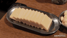 slices of cheese on a tray that says made in animatica