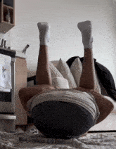 a person laying on their back with their legs up and a towel that says " cooking "