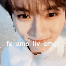 a close up of a person 's face with the words `` te amo liv amor '' written in white .