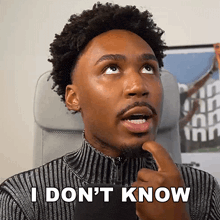 a man with curly hair is making a funny face and saying i don 't know .
