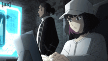 a man and a woman are looking at a computer screen with the letters [ as ] on it