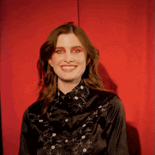 a woman wearing a black shirt with white flowers on it