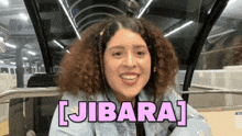 a woman with curly hair says jibara in pink
