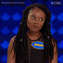 a woman with dreadlocks and a name tag that says asha