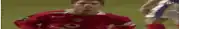 a soccer player in a red jersey is standing on the field .