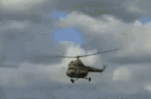 a blurry picture of a crowd watching a helicopter take off