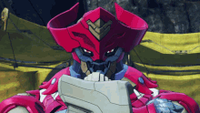 a red robot is holding a piece of paper in front of his face