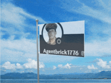a flag with a picture of a man and the name agentbrick1776 on it