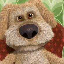 a stuffed animal dog is sitting on a red pillow .