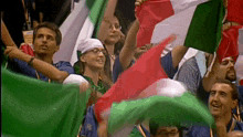 a group of people holding up flags in a crowd