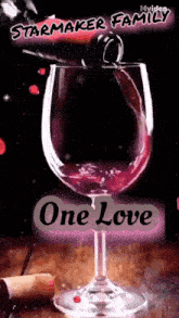 a glass of red wine with the words one love on it