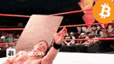 a man in a wrestling ring with a 21bitcoin logo