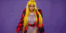 a woman with long yellow hair is wearing a red and black plaid jacket and a bodysuit .