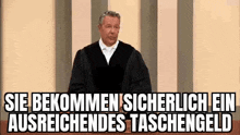 a man in a judge 's robe is giving a speech in front of a striped wall .
