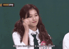 a girl in a white shirt and tie is smiling and saying well i didn 't guess it