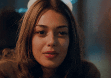 a close up of a woman 's face looking at the camera