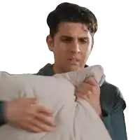 a man is holding a white pillow in his hands and making a funny face