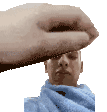 a hand is holding a man 's head in a pixelated image .
