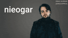 a man with a beard is standing in front of a poster that says nieogar